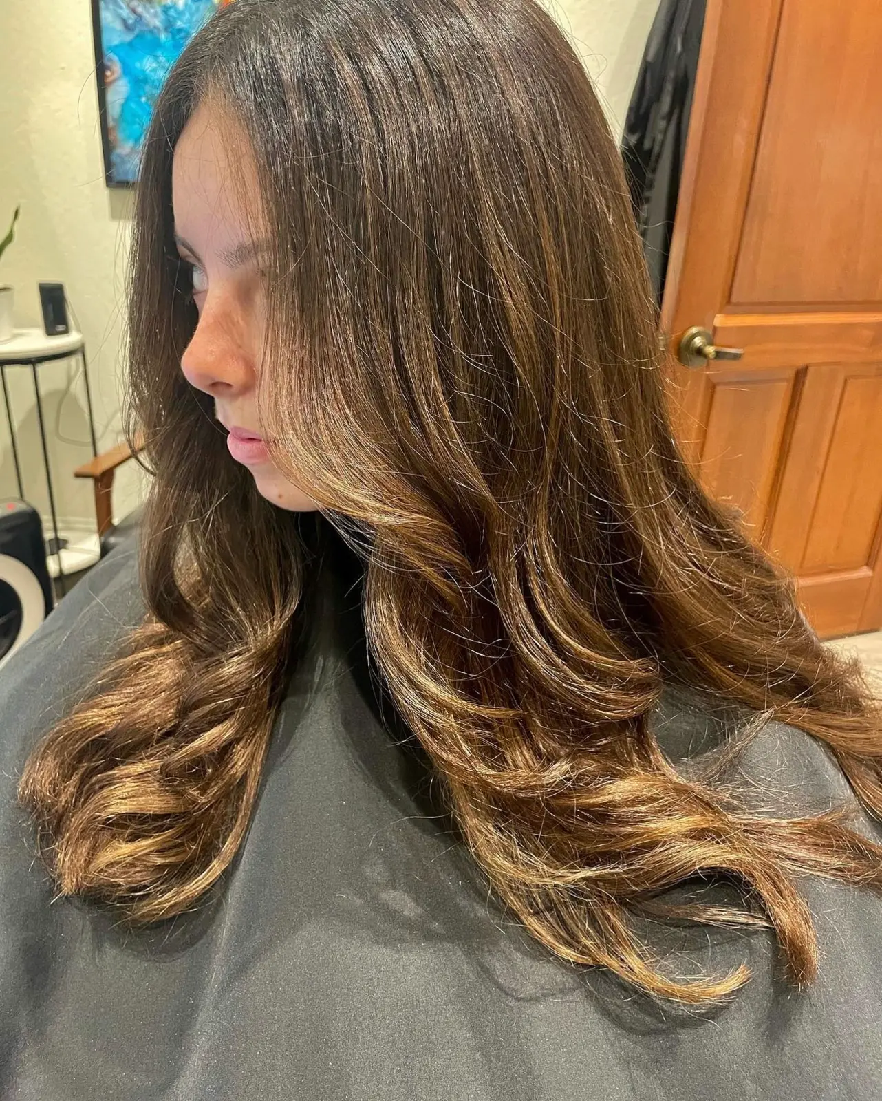 Glossy brunette layers with warm face-framing highlights