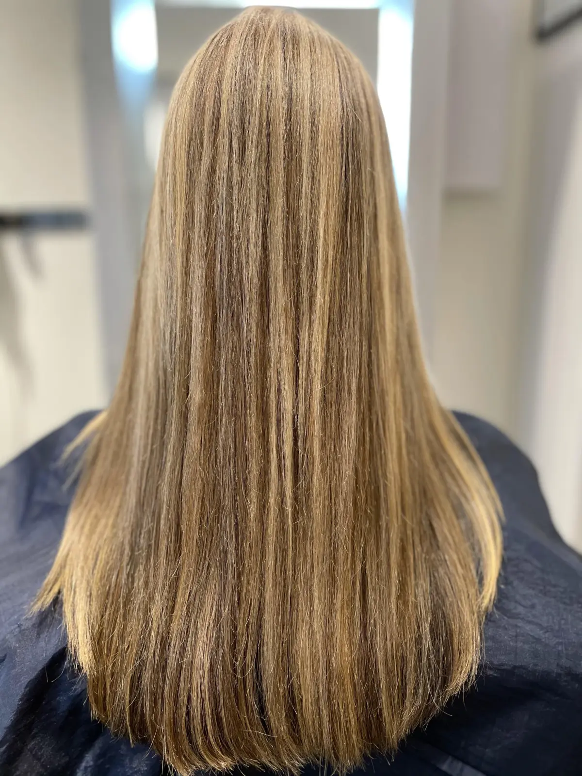 Long smooth hair after a warm dimensional color refresh